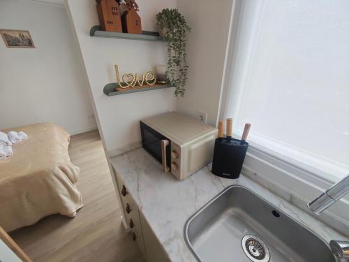 a small kitchen with a sink and a microwave at Galamares Nest in Sintra
