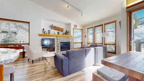 a living room with a couch and a fireplace at Snowcreek V #777 in Mammoth Lakes