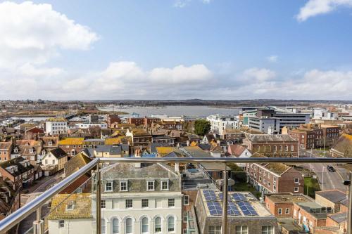 a view of a city with a river and buildings at A Wave From It All - Extensive Harbour Views from Wrap-Around Balcony in Poole