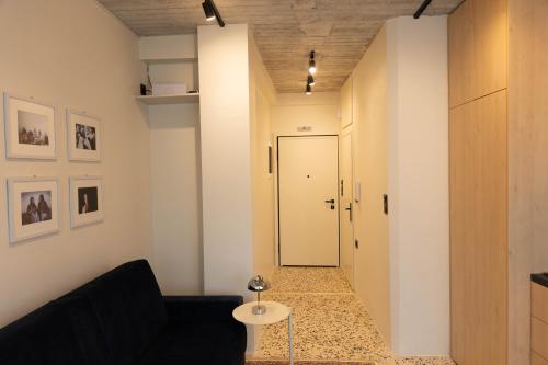 a living room with a black couch and a door at Echoes of Thrace in Xanthi