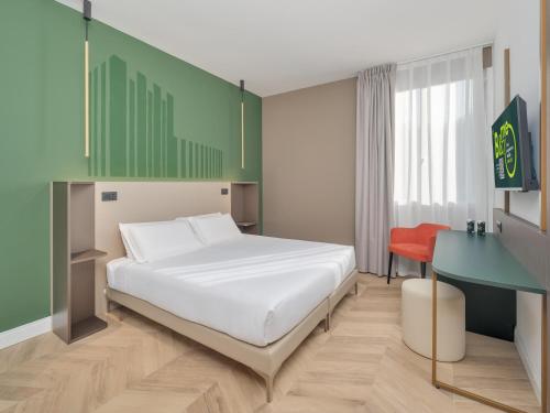 a bedroom with a bed and a desk at B&B HOTEL Calenzano First in Calenzano