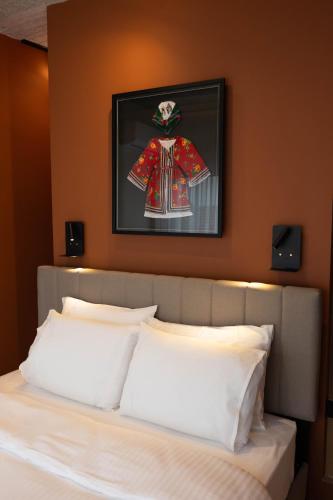 a bedroom with a bed with a picture on the wall at Echoes of Thrace in Xanthi