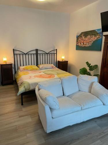 a living room with a bed and a white couch at borgo nel vigneto 2 in Erbusco