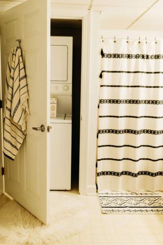 a bathroom with a shower curtain next to a door at Sol Sage Studio Downtown in Wilmington