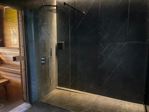 a shower with a glass door in a bathroom at Nice getaway, 20 min from Tallinn in Järsi