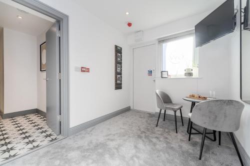 a dining room with a table and two chairs at The Madison - Premium Self Check-In Studios & Apartments in Southampton