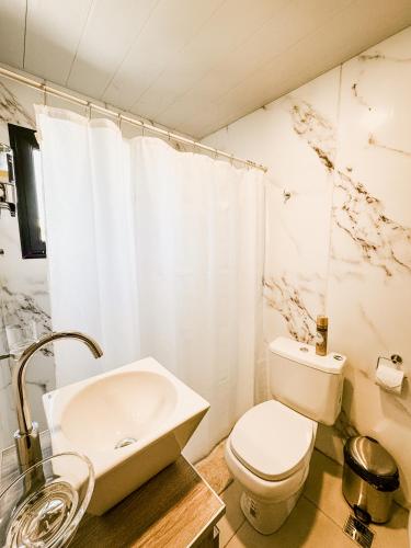 a bathroom with a toilet and a sink at Cabañas Lihuen in Caviahue