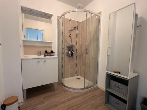 a bathroom with a shower and a sink at Les cabines de Granville in Granville