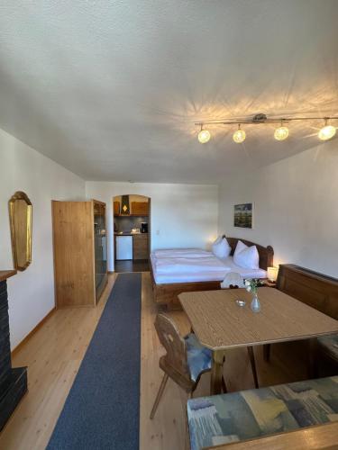 a hotel room with a bed and a table and a room at Gästehaus Gastl in Mieming
