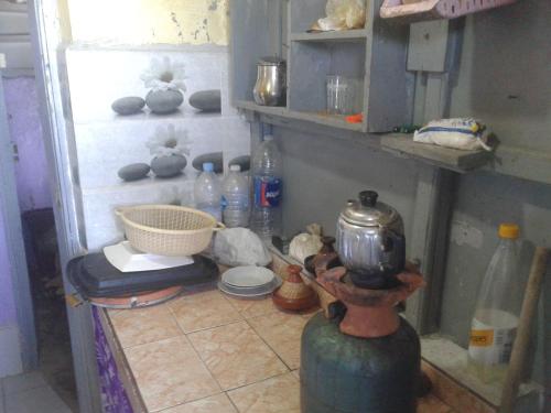 a kitchen with a counter with a tea kettle on it at Grotte Panoramique Atlantique d'Aglou in Zaouia Sidi Ouaggag