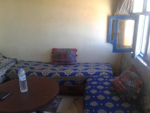 a living room with a couch and a table at Grotte Panoramique Atlantique d'Aglou in Zaouia Sidi Ouaggag