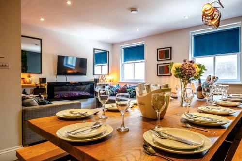 a dining room with a table with plates and wine glasses at West Pier Beach - by Brighton Holiday Lets in Brighton & Hove