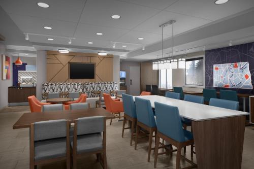a dining room with a table and chairs at Holiday Inn Express Fargo - West Acres by IHG in Fargo