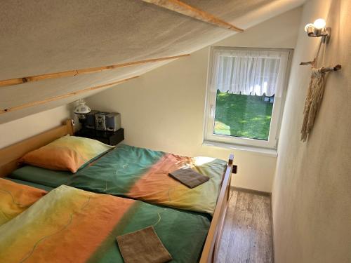 a bedroom with a bunk bed and a window at Beba in Heřmanovice