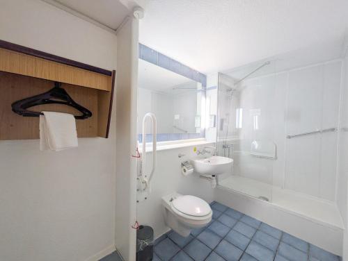 a bathroom with a toilet and a sink and a shower at The Beacon Hotel, Cardiff, Part of the AG Collection in Cardiff