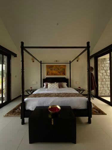 a bedroom with a large bed with a bowl on a table at Gulab Bagh Jawai in Jawāi Bāndh