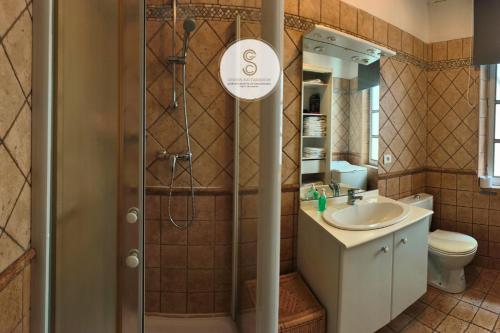 a bathroom with a shower and a sink at Arène Arles Centre in Arles