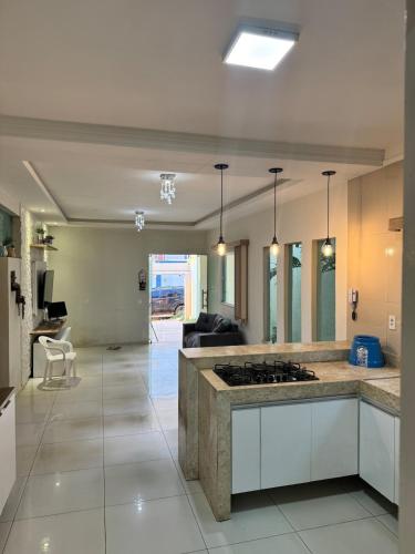 a kitchen with a stove top in a room at Casa completa com 3 quartos,ar e garagem in Sobral