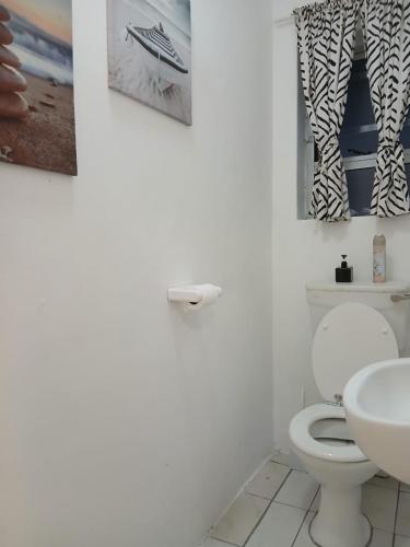 a bathroom with a toilet and a sink at DigiStay in Simonʼs Town