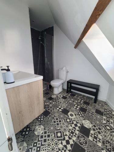 a bathroom with a sink and a toilet at Le nid de Marceline in Lannion
