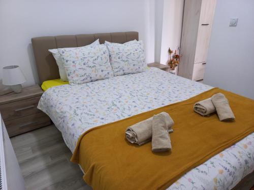 a bedroom with a bed with two slippers on it at Konak Jerma-Kanjon Jerme Pirot in Pirot
