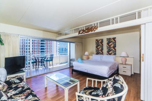 a hotel room with a bed and a living room at Ilikai Tower 1842 in Honolulu