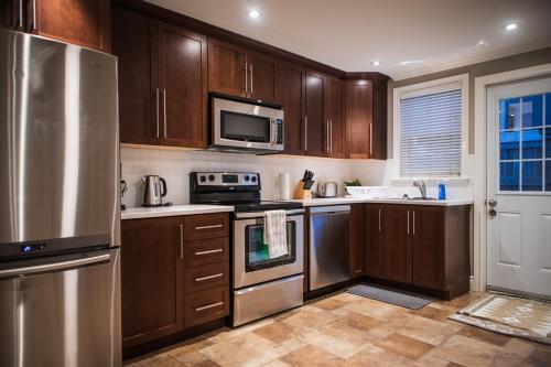 a kitchen with wooden cabinets and stainless steel appliances at 92179 Newfoundland & Labrador Limited in St. John's