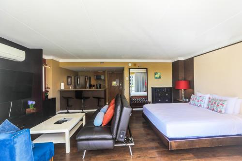 a hotel room with a bed and a couch at Ilikai Tower 420 in Honolulu