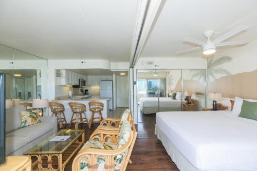 a bedroom with a bed and a living room at Ilikai Tower 633 in Honolulu