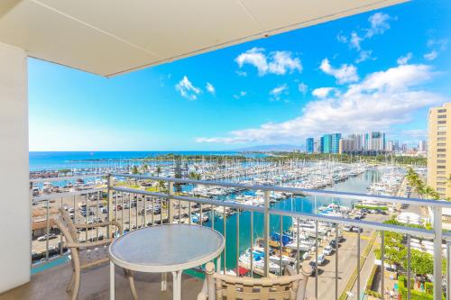 a balcony with a view of a marina at Ilikai Tower 943 in Honolulu