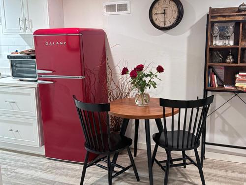 a red refrigerator in a kitchen with a table and chairs at Private Oakland Hills Guest Apartment in Oakland