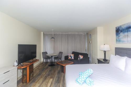 a hotel room with a bed and a living room at Ilikai Marina 1381 in Honolulu