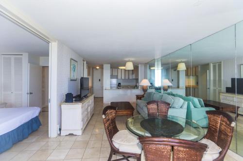a living room with a couch and a glass table at Ilikai Marina 1584 in Honolulu