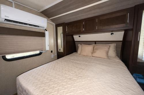 a bedroom with a bed in an rv at Rincon Camper Retreat in Rincon
