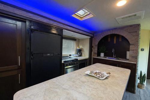 a kitchen with a table and a blue ceiling at Rincon Camper Retreat in Rincon