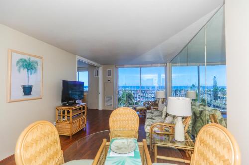 a living room with a table and chairs at Ilikai Marina 682 in Honolulu