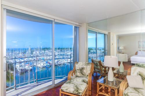 a living room with a view of a marina at Ilikai Marina 682 in Honolulu