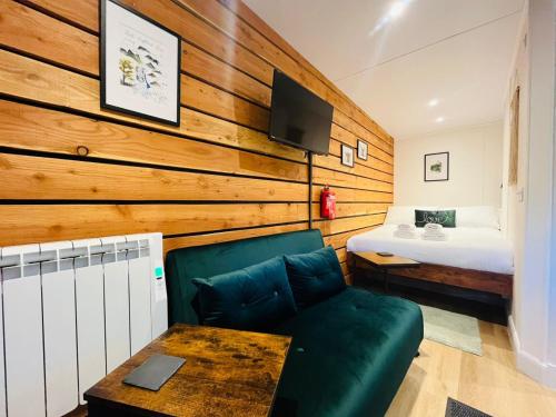 a living room with a couch and a bed at The Canal Cabin in Banavie