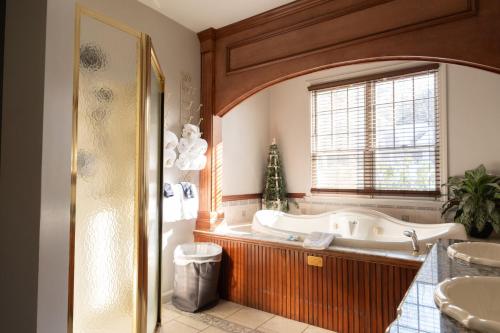 a bathroom with a tub and a window at Nordic Village Condominium Resort in Jackson