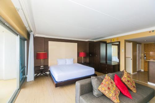 a hotel room with a bed and a couch at Ilikai Tower 404 in Honolulu
