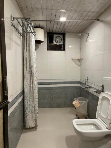 a bathroom with a toilet and a sink at Amor Villa Abu in Mount Ābu
