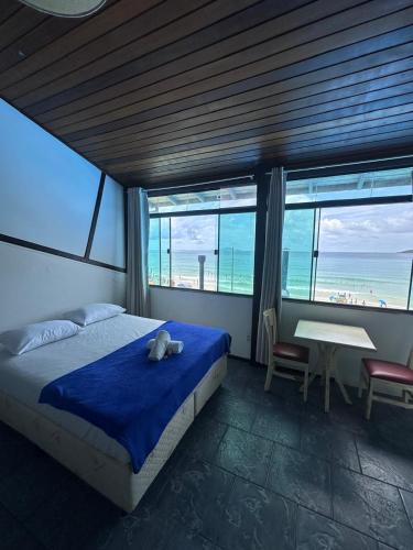 a bedroom with a bed and a view of the ocean at Vista Beach Ingleses in Florianópolis