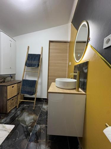 a bathroom with a sink and a mirror at L'instant étoilé in Châteauneuf-lès-Martigues