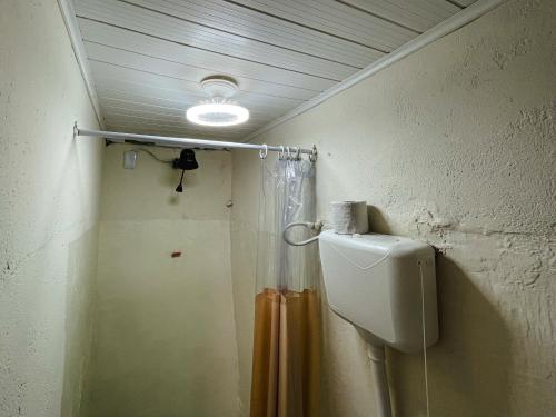 a bathroom with a shower and a toilet at Colombia Hostel in Porto Seguro