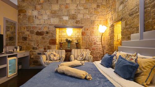 a living room with a bed with pillows on it at Eski Masal Hotel - Special Class in Antalya