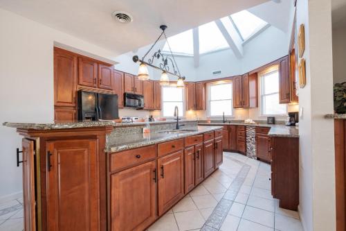 a large kitchen with wooden cabinets and a sink at Nordic Village Condominium Resort in Jackson