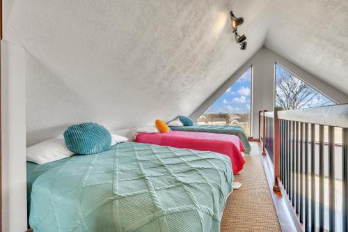 a bedroom with two beds and a balcony at Bridges Bay Vacation Cabin 33 in Arnolds Park