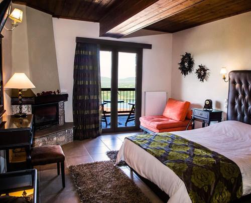 a bedroom with a bed and a living room with a balcony at Χρυσοπελεια - Chrisopeleia Lake View in Neochori