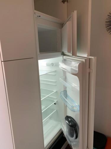 an empty refrigerator with its door open with its door open at Vaticano luxury sleep in Rome