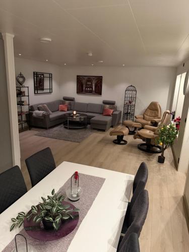 a living room with a table and a couch at Villaveien in Sortland